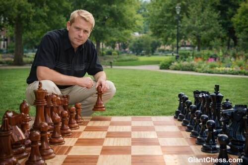 Giant teak chess set photo