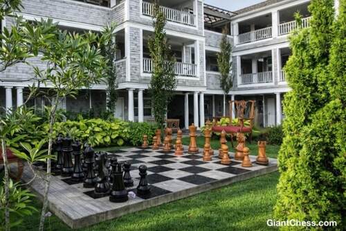 Giant teak chess set photo